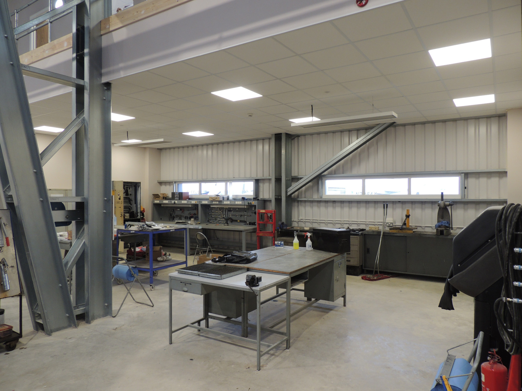 EEZ Medium wave infrared heaters under a mezzanine area in a warehouse